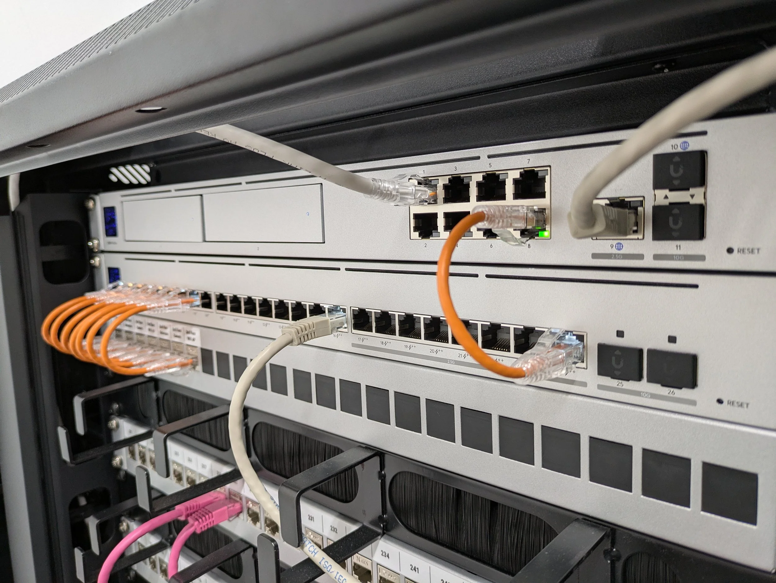 Close-up of a server rack with network switches and cables connected.