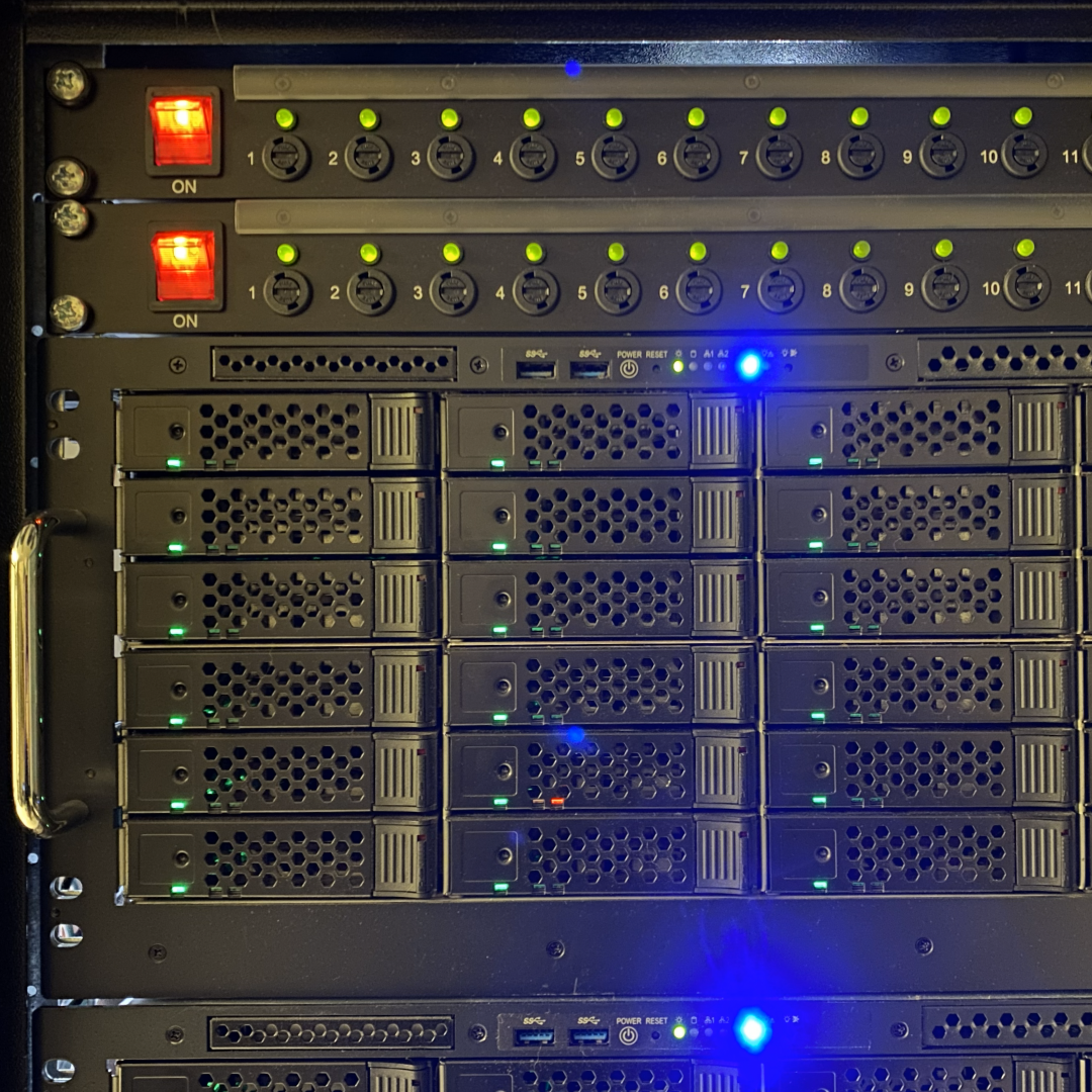 A rack-mounted server with illuminated indicator lights, switches, and cooling vents.