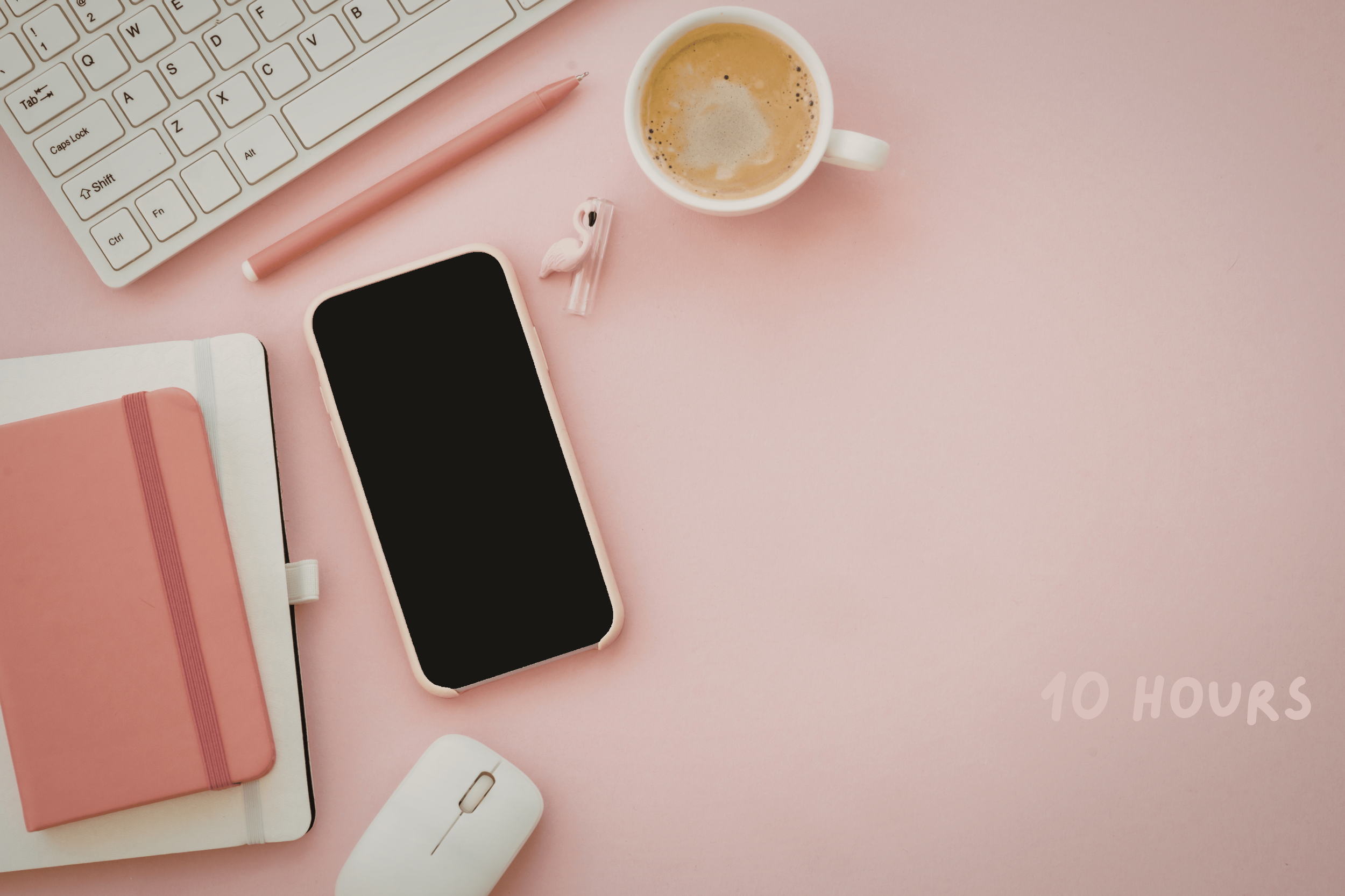 A pink desk setup featuring a white keyboard, pink pen, pink notebooks, a smartphone with a black screen and pink case, a white computer mouse, a cup of coffee, and a small pink flamingo figurine. The words "10 HOURS" are written in the bottom right corner in light pink.