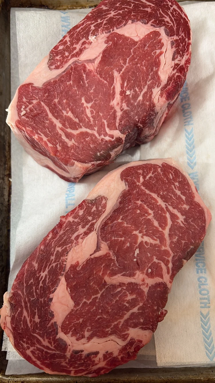 Raw marbled beef steaks on butcher paper