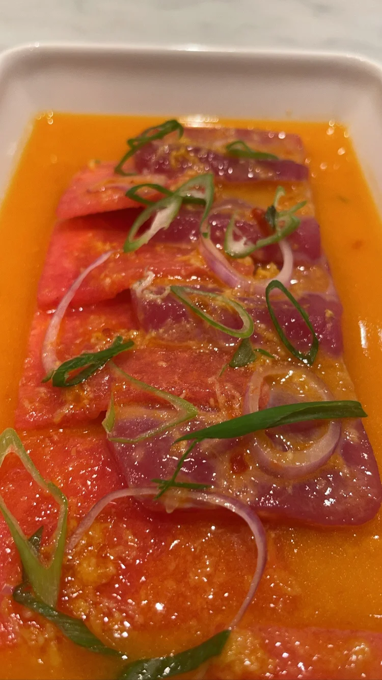 Sliced raw fish in orange marinade