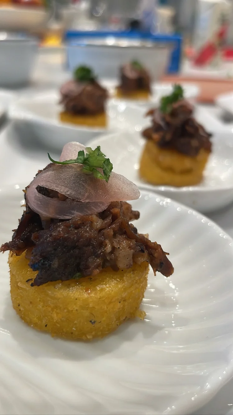 Plated appetizer with shredded meat and herbs