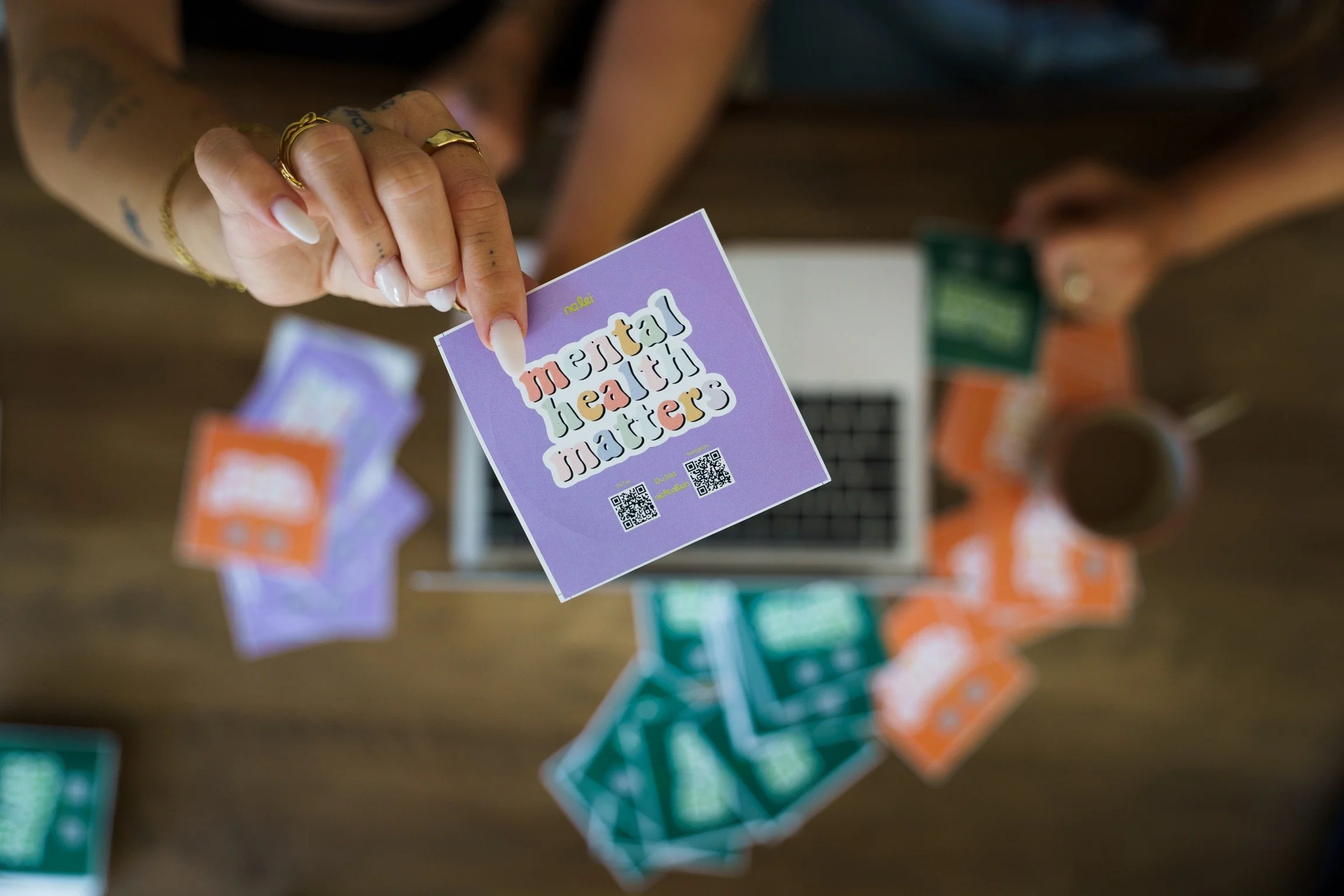 Laurie’s customers, Mariana and Carmen holding hands on a green lawn on their wedding day.