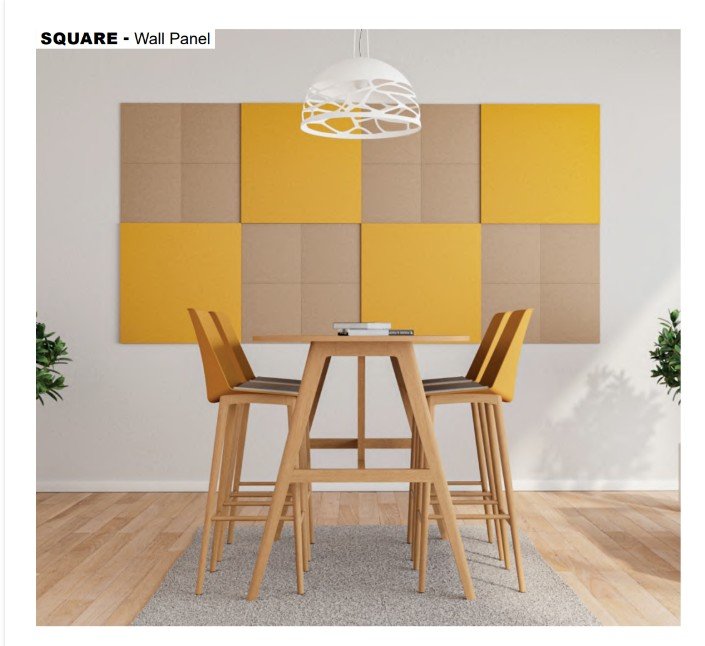 Interior dining area with a wooden high-top table, four wooden chairs with yellow and wood-colored seats, a gray area rug, wall-mounted acoustic panels in yellow and natural wood tones, a modern white hanging light fixture, and potted plants in the background.