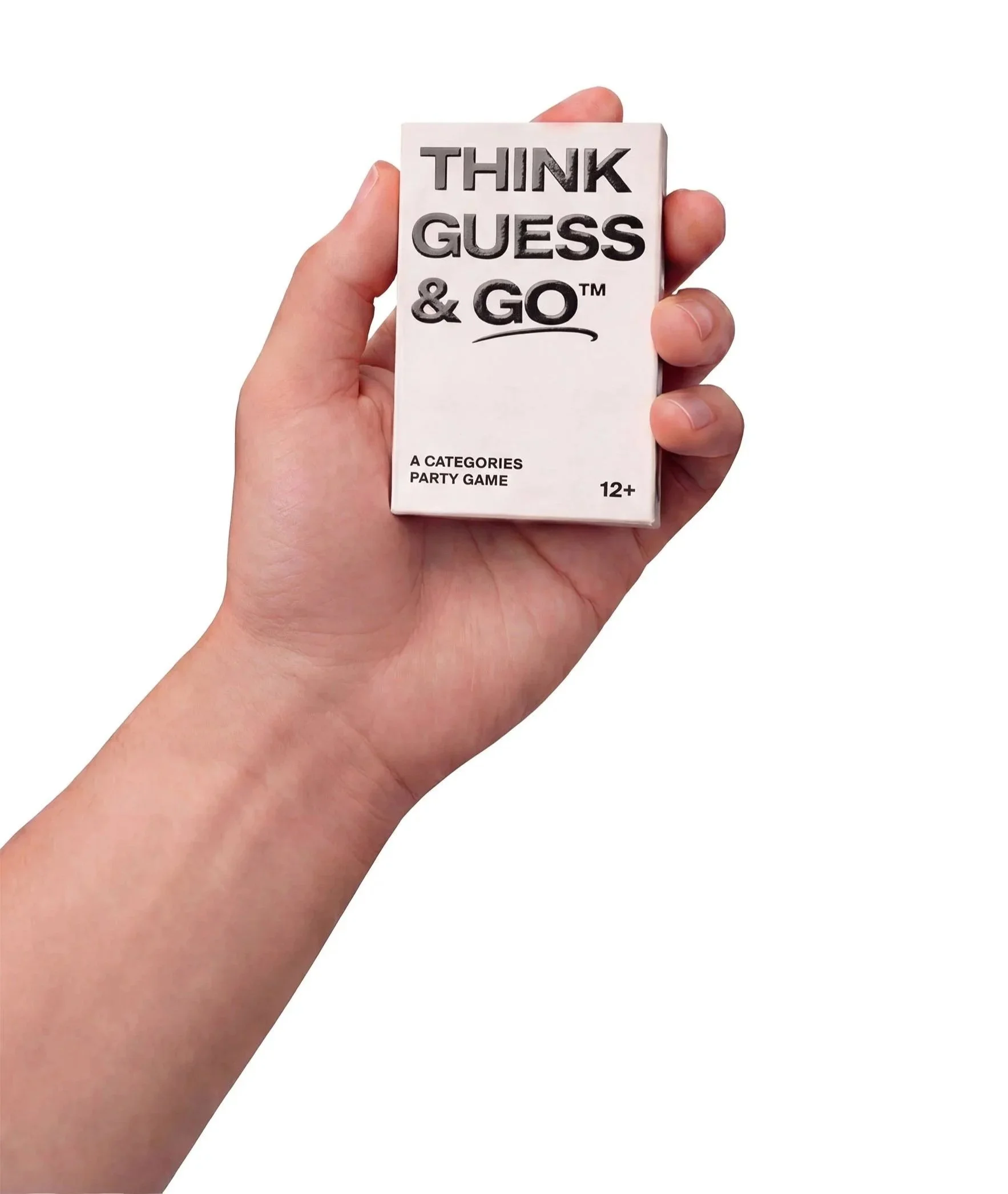 A person holding a small white box with the words "Think Guess & Go" printed on it, indicating a party game age 12 and up.
