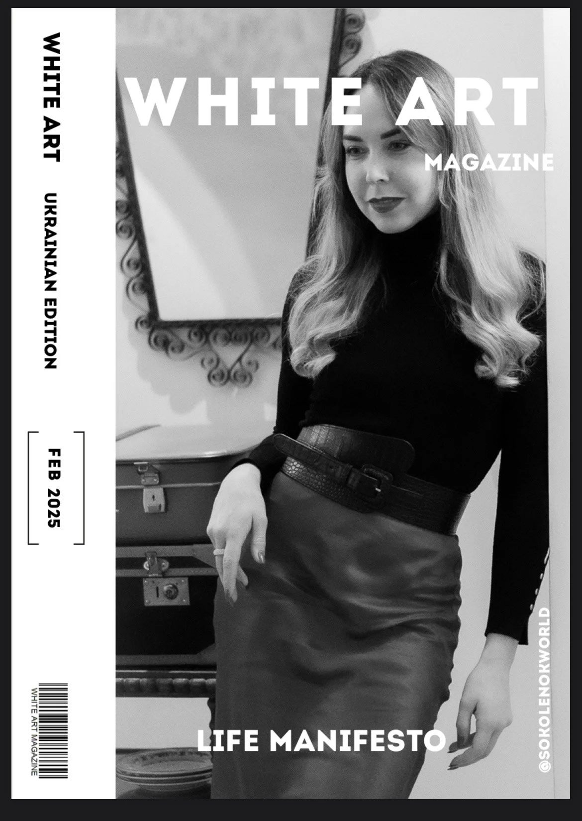 A woman with long, wavy hair, wearing a black turtleneck and a leather skirt, posing indoors near a mirror, on the cover of a black and white art magazine.