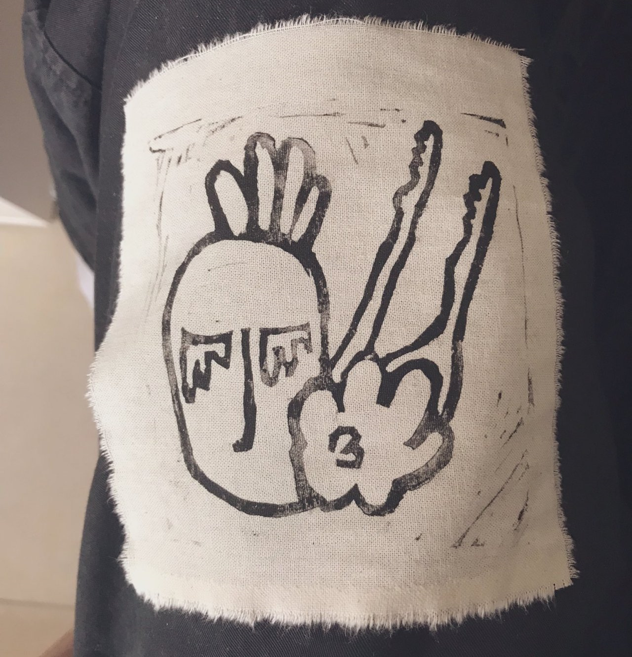 A sketch of a hand making a peace sign with two fingers extended, accompanied by a stylized head with closed eyes, and the number 3 inside a heart-shaped cloud at the wrist.