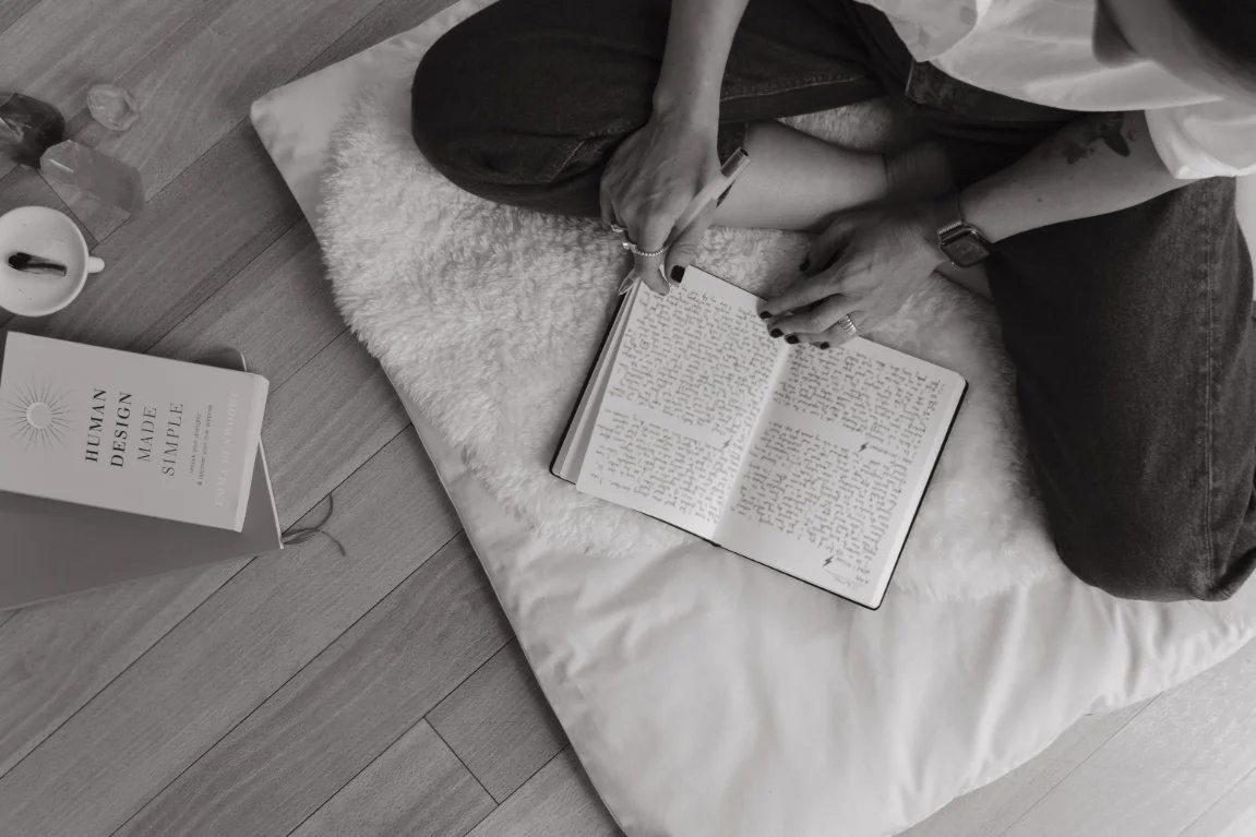 Woman journaling - corporate strategist, yoga teacher, Reiki practitioner, systems nerd, sound healer