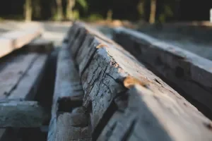 Close-up of weathered wooden railroad ties on a train track.