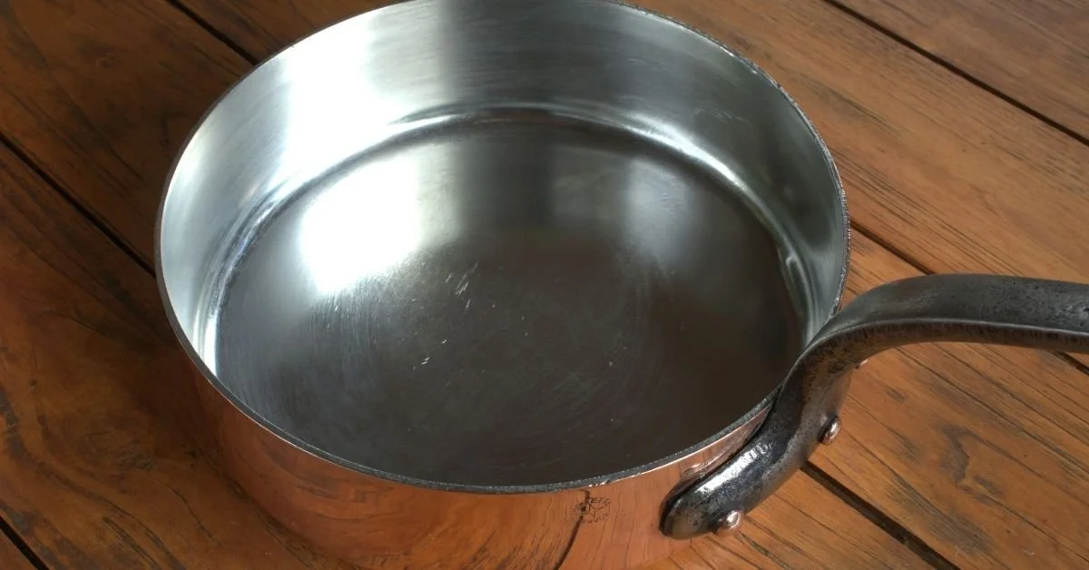 stainless steel pan on wooden surface