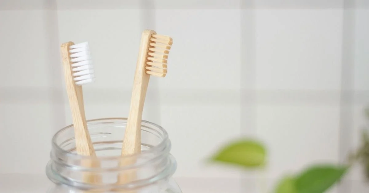 two bamboo brushes in glass jar