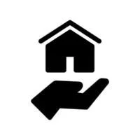 A silhouette of a hand holding a small house icon with a roof and door.