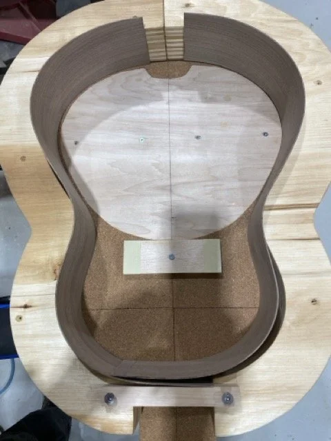 The sides of the guitar being places inside the SOLERA