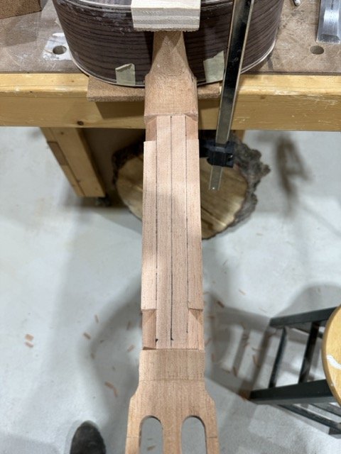 Shaping the neck. Lines are drawn to help withe the removal of material.