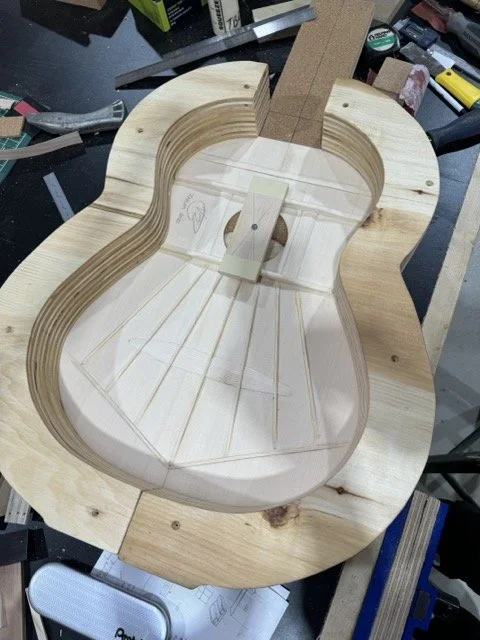 Here the sides have beed attached to the Solera after the soundboard has been properly placed in place and temporarily secured so it does not move 