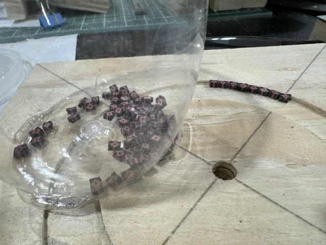 They are then cut into tiny pieces which will be placed into the cutout around the sound hole to form the rosette