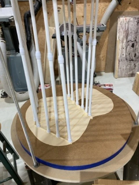 More harmonic braces and bars are glued to the interior of the sound board 