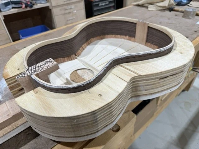 The mini clamps are removed showing the cedar strip around the sides to which the back will be glued to.