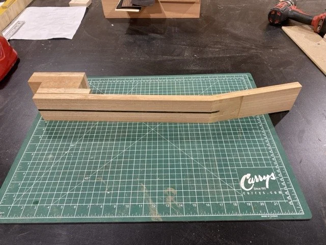 The Spanish Cedar black that has been cut into pieces and glued together to form the guitar neck