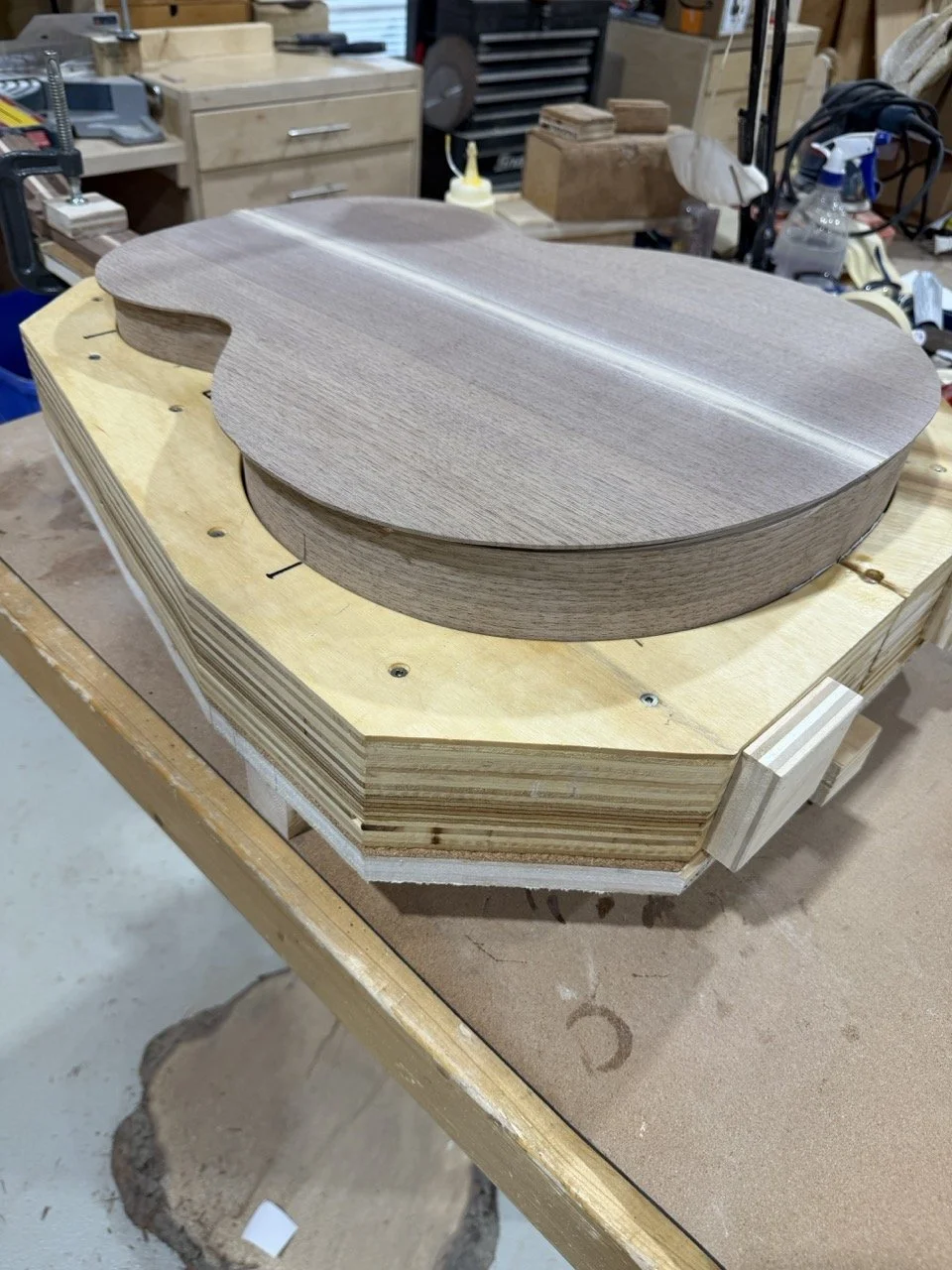 The back being glued to the body of the acoustic guitar