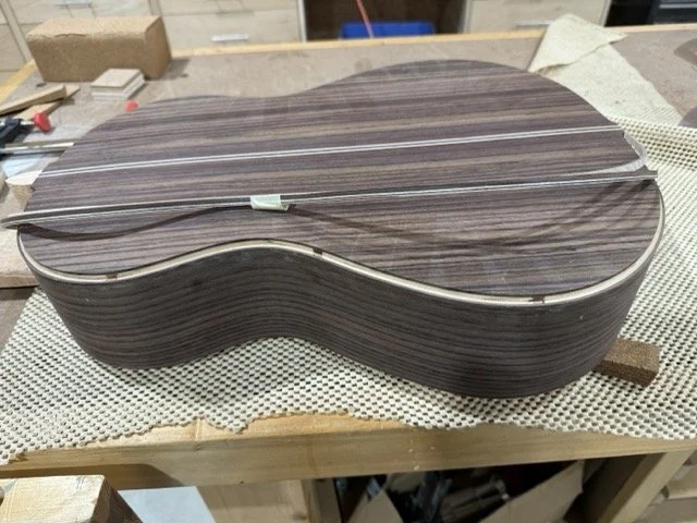 The channel cut for the back and sides with the binding strip to be adhered