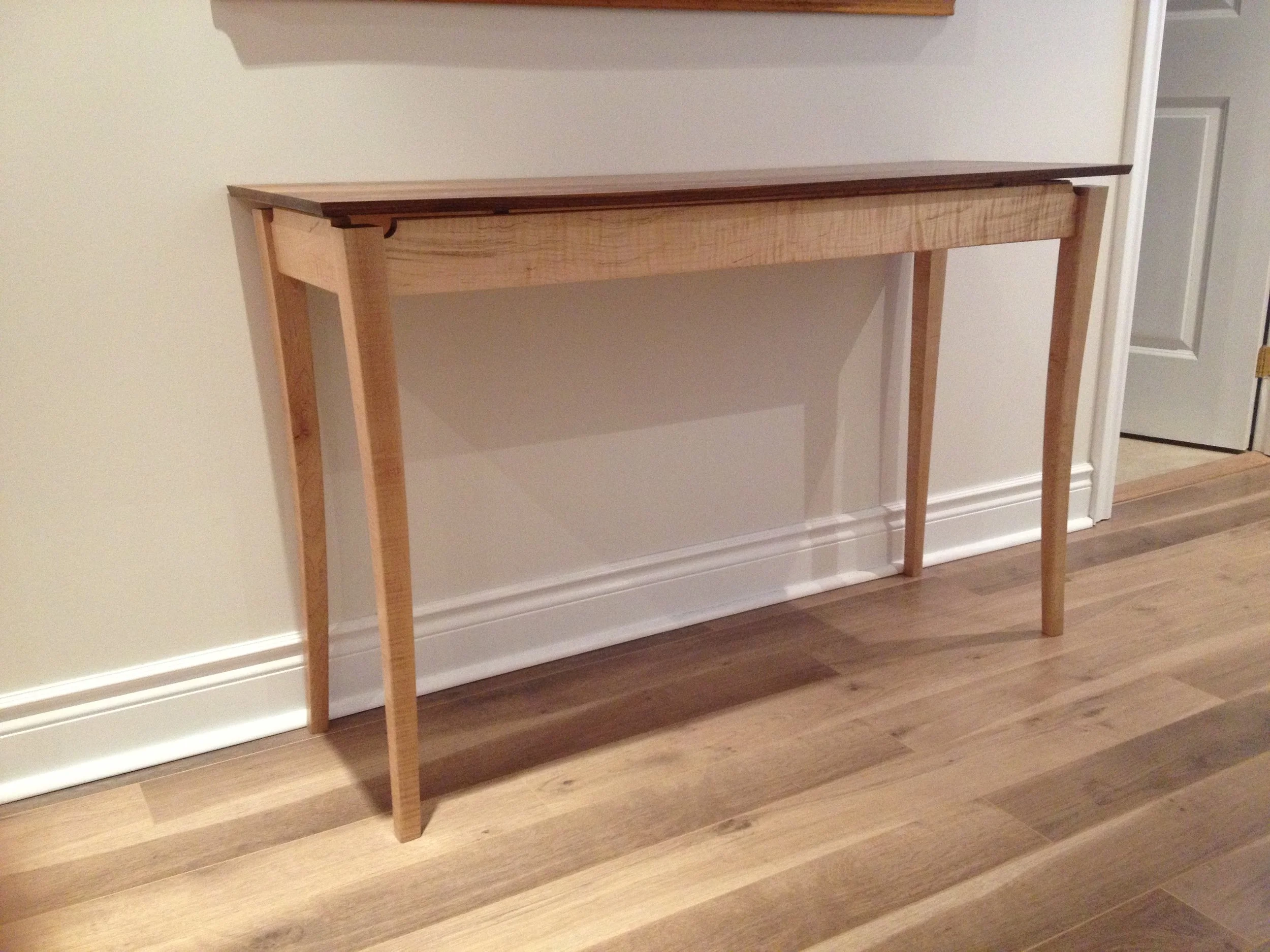 Zarum's woodworking skills. Curved leg curly maple table legs with a floating walnut top.