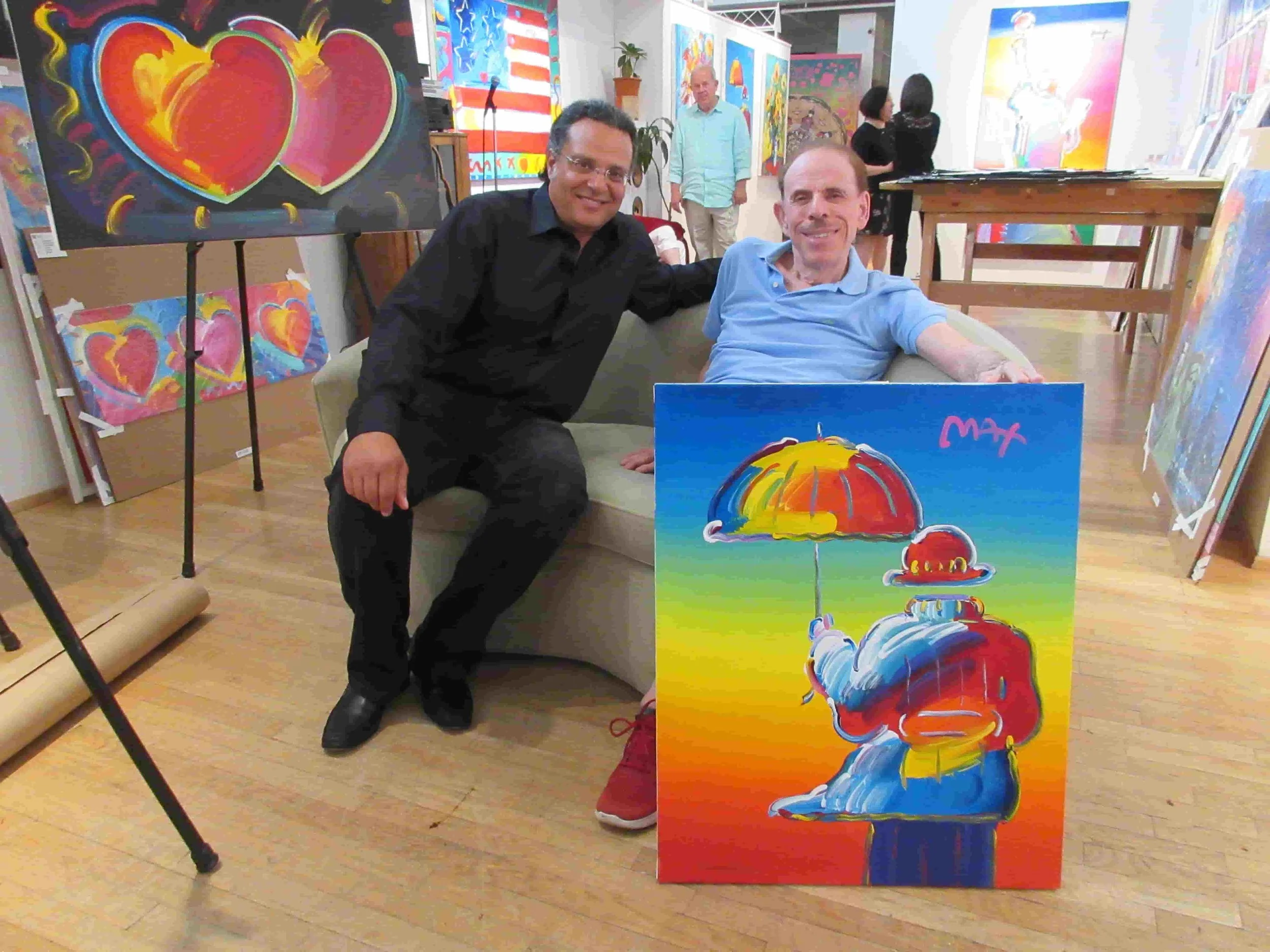 The artist ZARUM with the artist Peter Max in his New York Studio with a Peter Max painting that Zarum bought to add to his collection.
