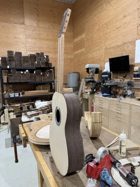 The assembled guitar is removed for the solera