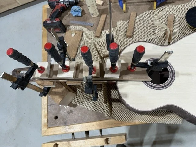 Clamping the ebony fretboard to the neck