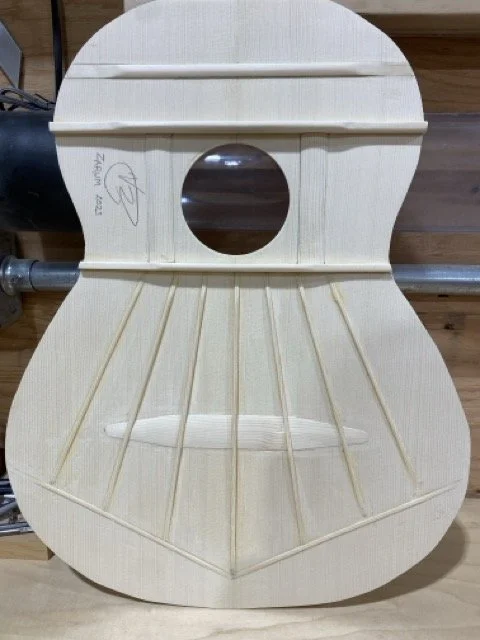 The completed interior of the sound board showing the harmonic bars and braces. Shown here is a Classical guitar pattern which differs slightly from a Flamenco guitar harmonic braces