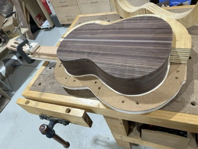 The back is glued to the guitar 