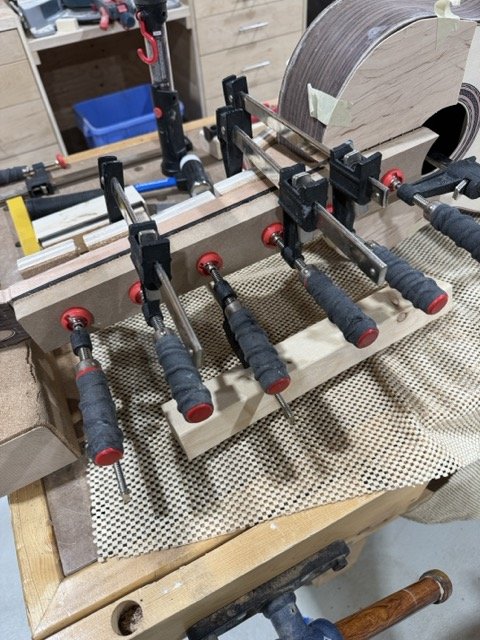 Clamping the ebony fretboard to the neck