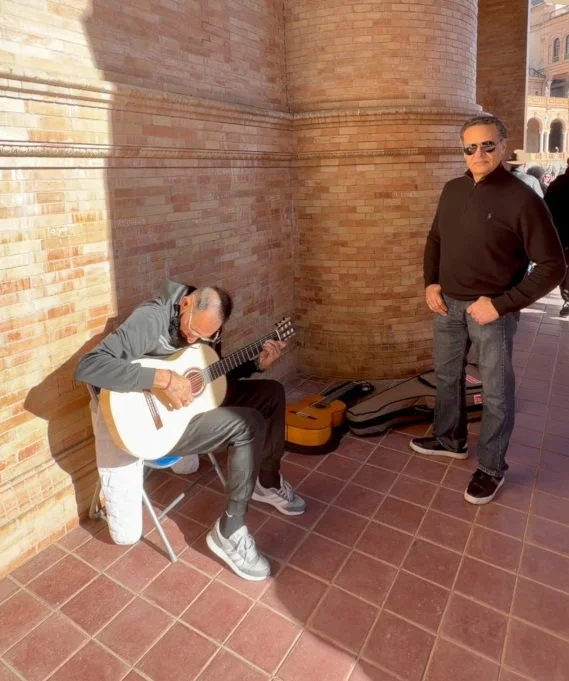Zarum listening to a guitarist play one of his Hand Crafted Flamenco Guitars at the Plaza de Espana, Seville, Spain. Zarum Flamenco Model ZFC.