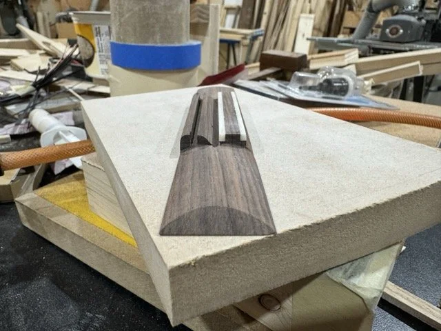 The ends of the bridge are shaped and the bridge is ready for finish. the open slot is where the bone saddle will be placed after the bridge is blued to the guitar. The saddle is not glued.