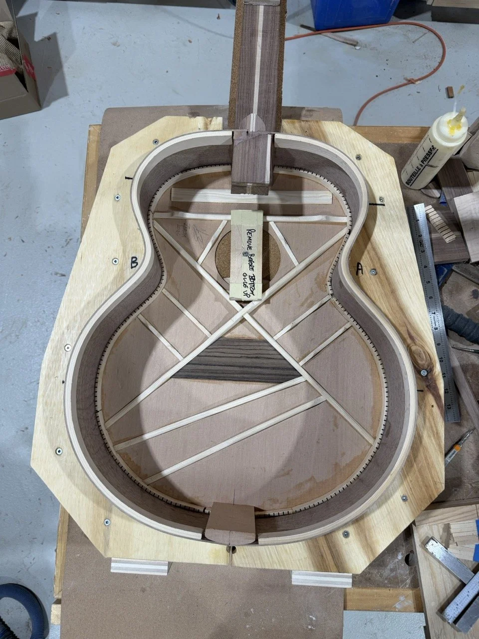 The acoustic body in the mold showing the Soundboard, Sides, and neck attached using the traditional Spanish heel joint of the sides to the neck. Providing superior tonal quality.