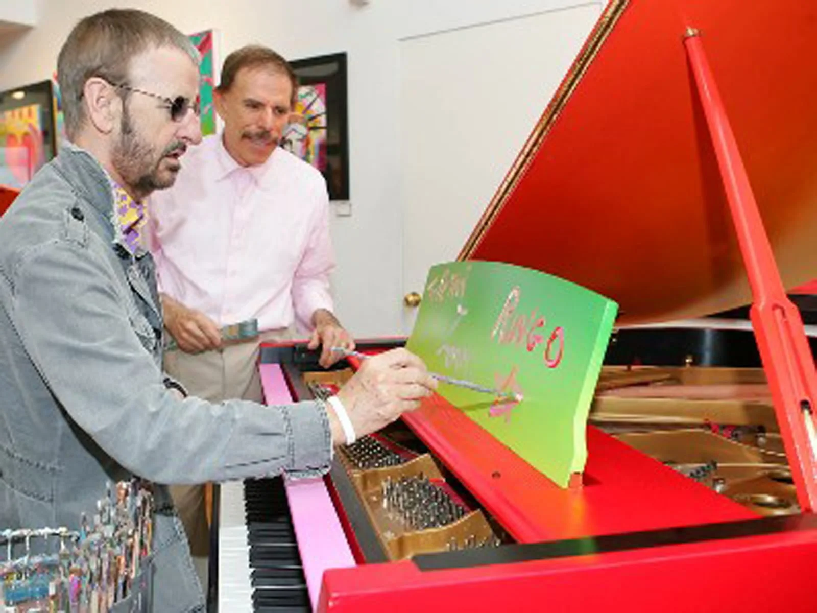 The piano that was painted by Peter Max and being signed by Beatle drummer Ringo Star.