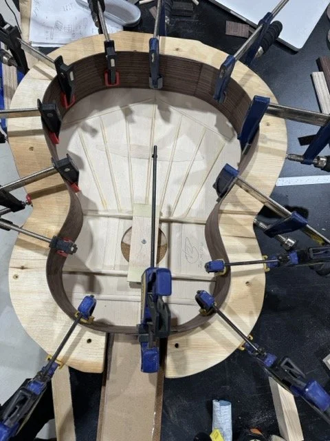 The bent sides are placed in the Solera mould on top of the sound board