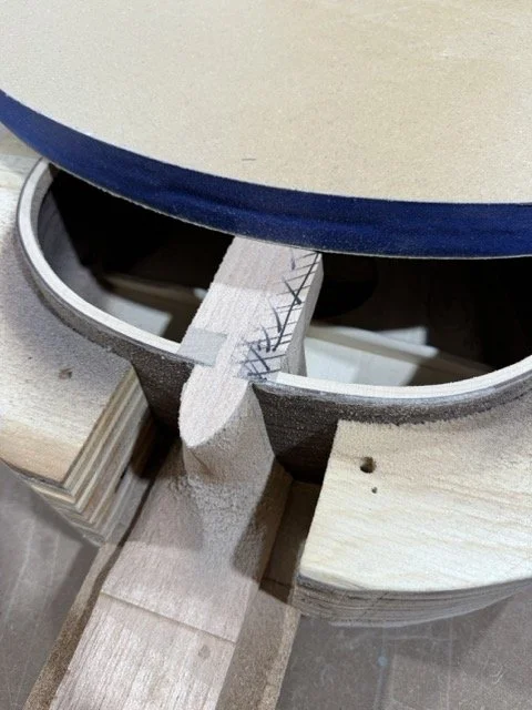 The back of the neck is scored and as the sanding continues it disappears as the proper shape is formed to glue the back to the guitar