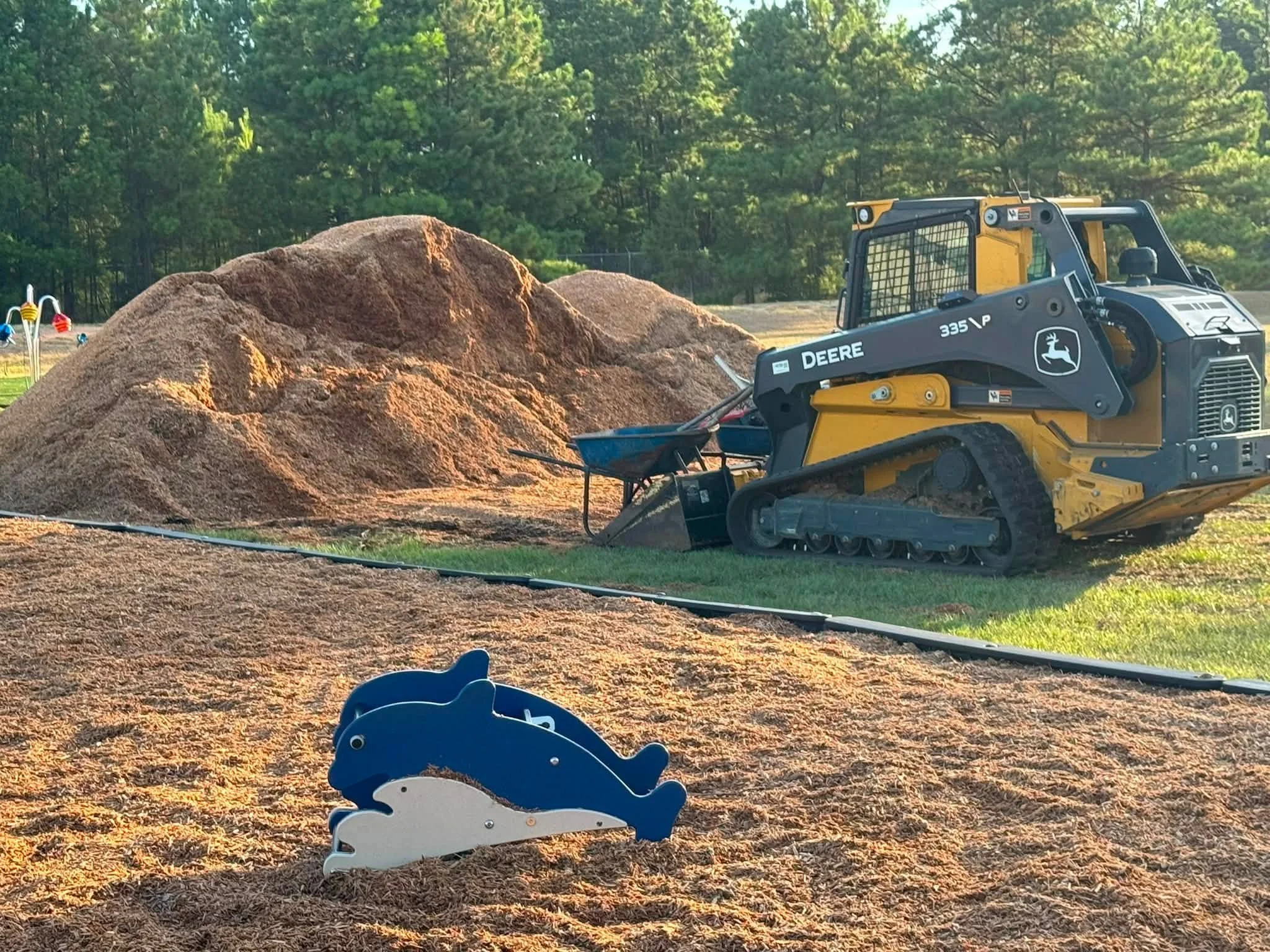 Bullard children's playground installation in progress with construction vehicles.