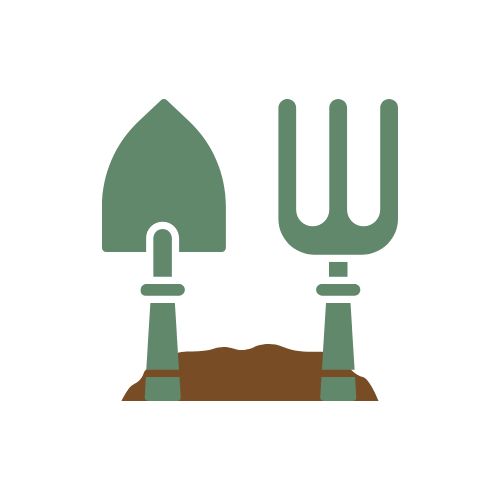 A shovel and a gardening fork stuck in the soil.