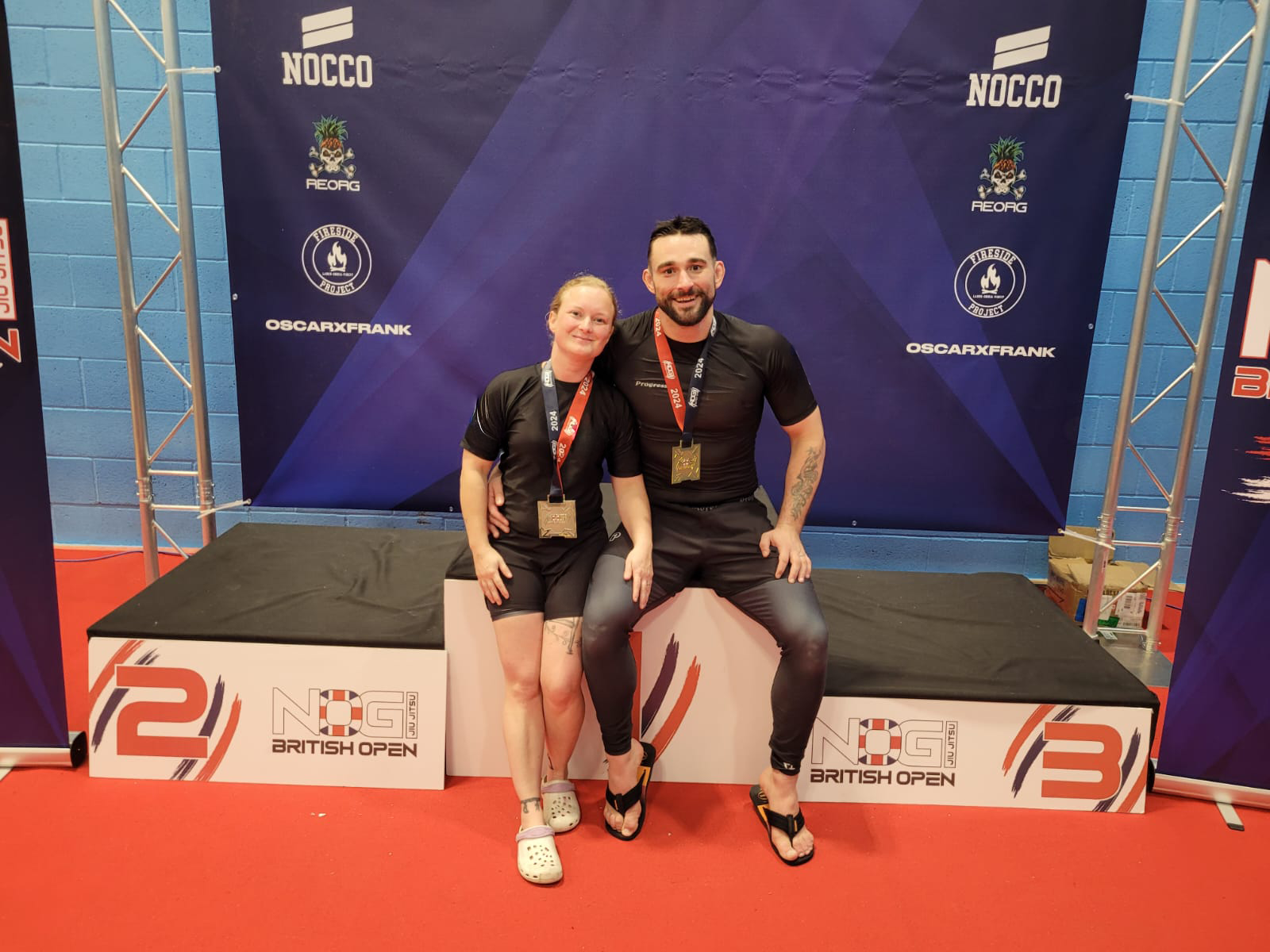 Swindon BJJ coaches Jake and Zena with gold medals at BJJ competition.