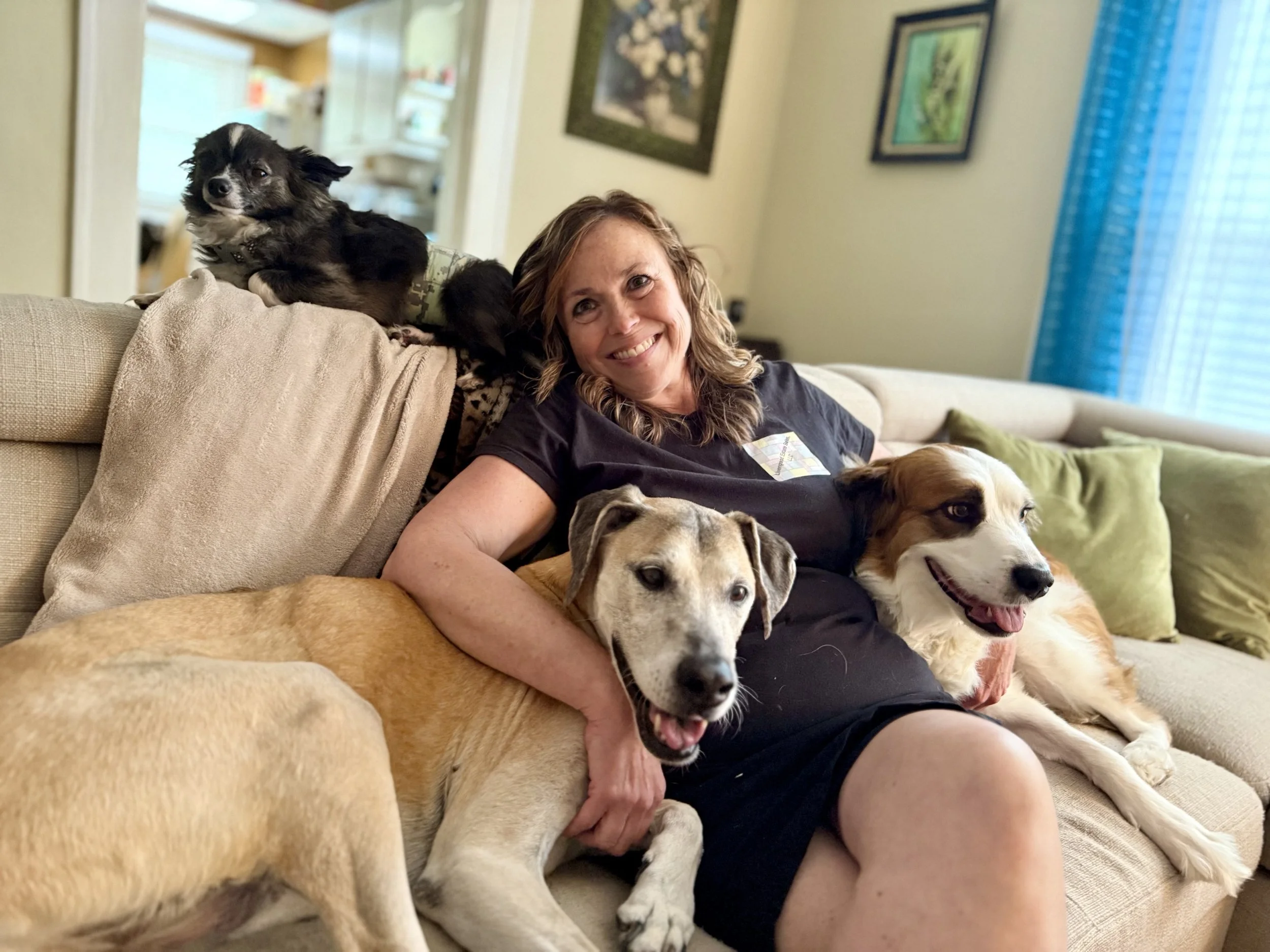 Missy, the owner, surrounded by her favorite pups (Laken, Frank, and Pepper).