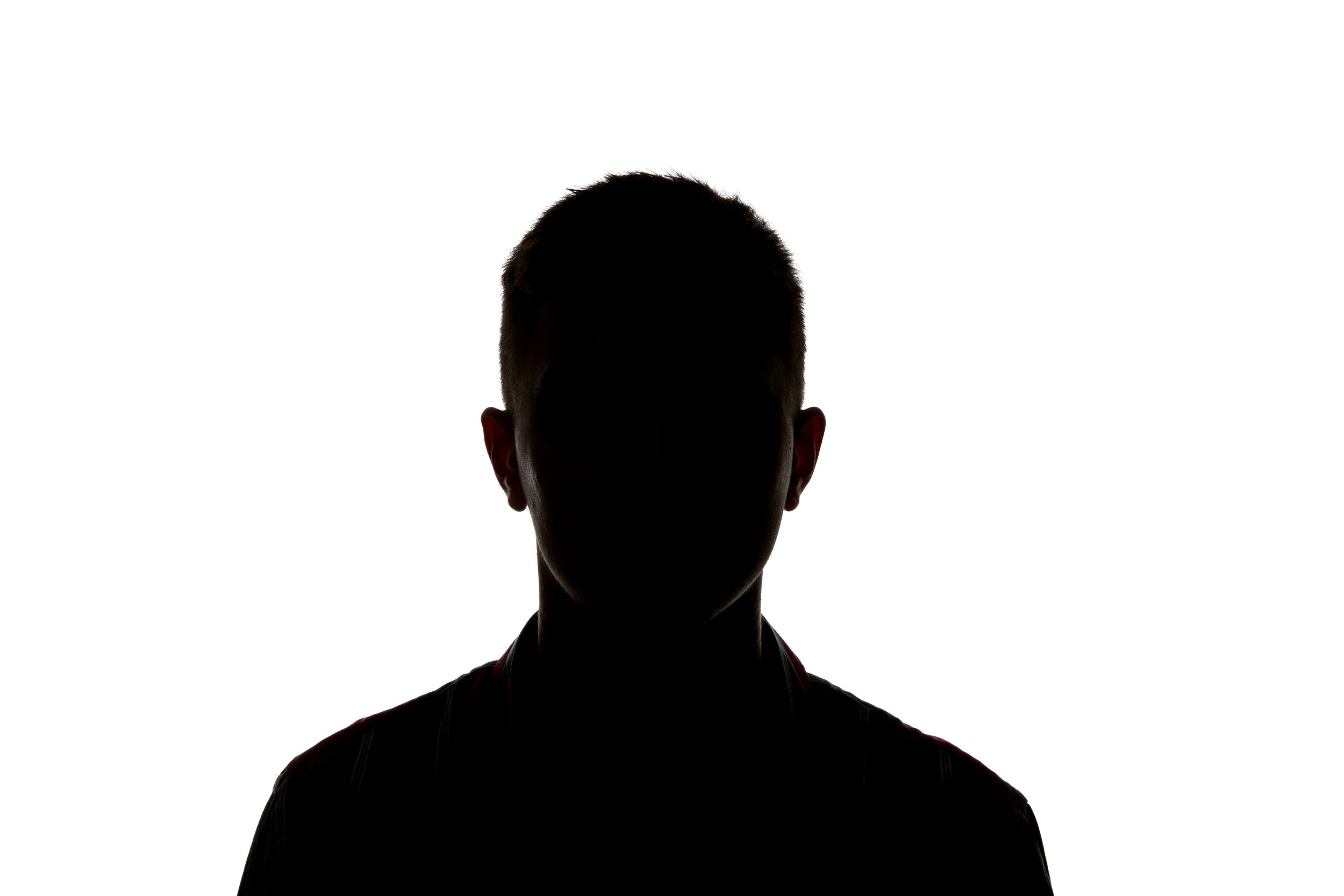 Silhouette of a person with short hair against a white background.