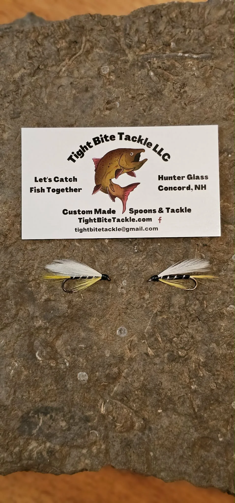 Business card for Tight Bite Tackle LLC with a fish graphic, contact information, and two fishing flies below it.