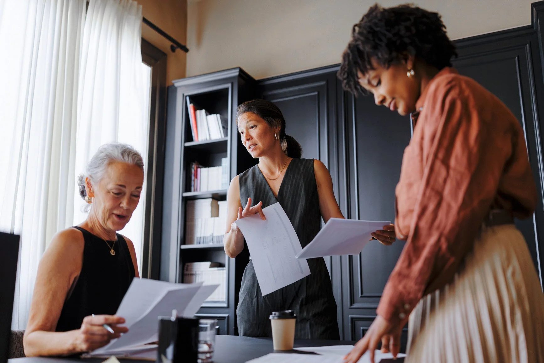 Legal professionals reviewing documents together in an office.