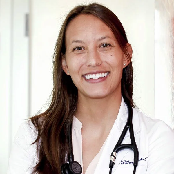A smiling female healthcare professional with long brown hair, wearing a white coat and a stethoscope around her neck.