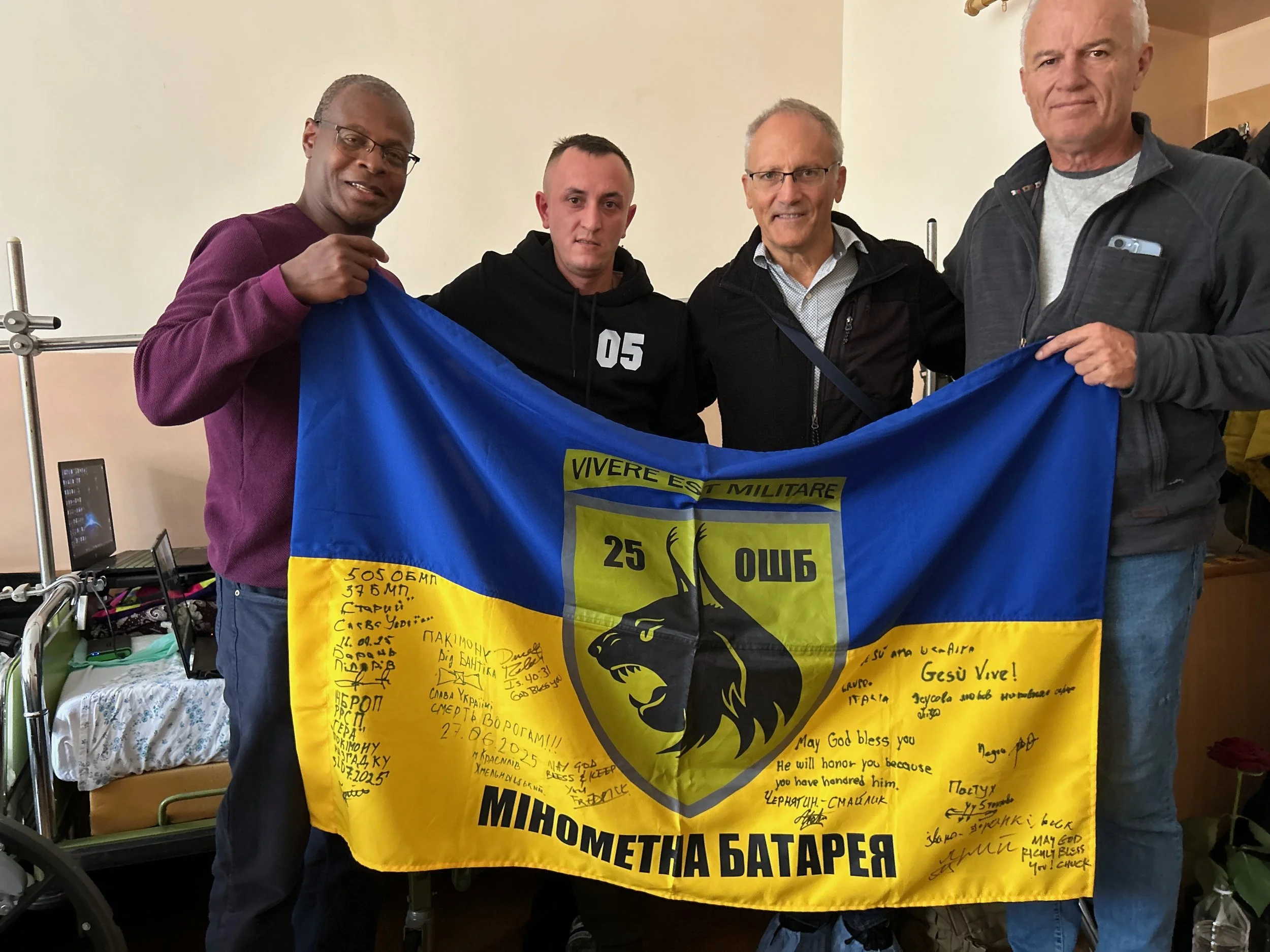 Each week, we minister to wounded soldiers in local hospital clinics. Recently, a soldier who lost a foot in the war asked us to sign his battalion flag after we ministered to him and prayed for him.