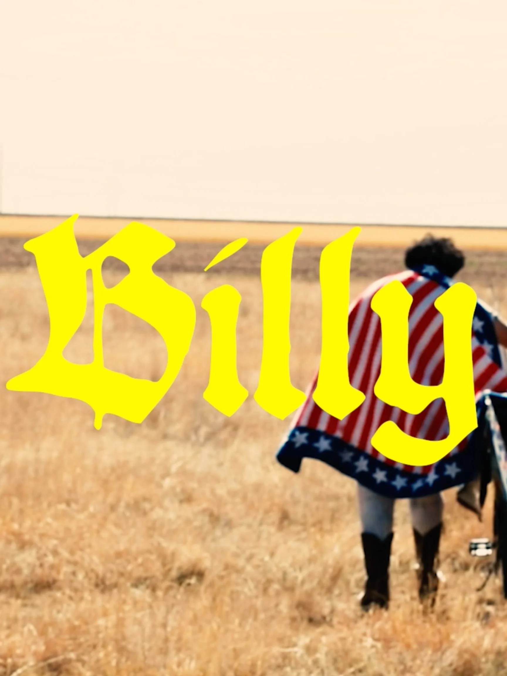 a man drags his bicycle across a field wearing an american flag as a cape, the title of the film is Billy