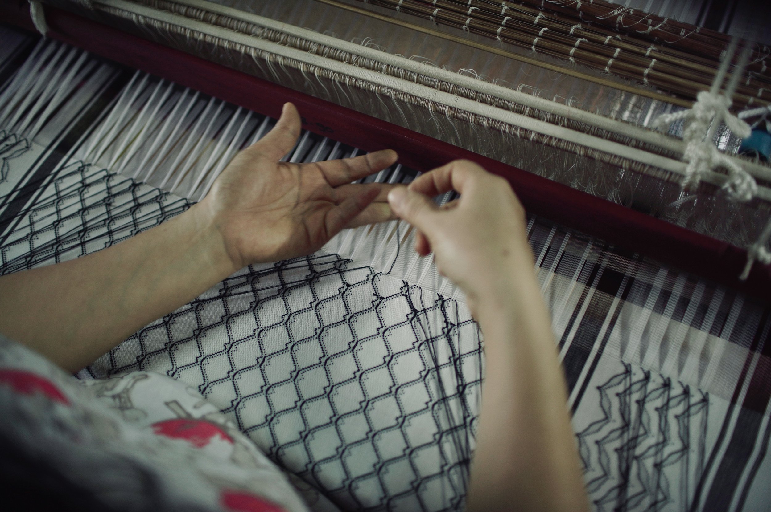 A smaller version of the photo of the weaver's hands.