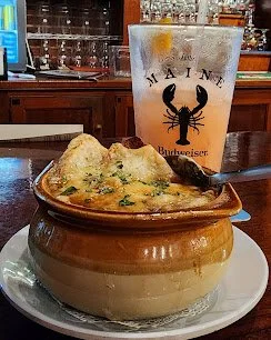 Our amazing Hot and delicious French onion soup at the bar with a refreshing beverage - waterworks rockland maine